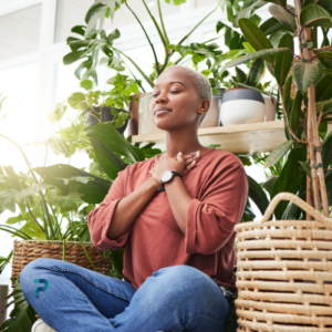 woman breathing sitting near plants