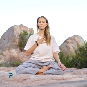 woman meditating on sand