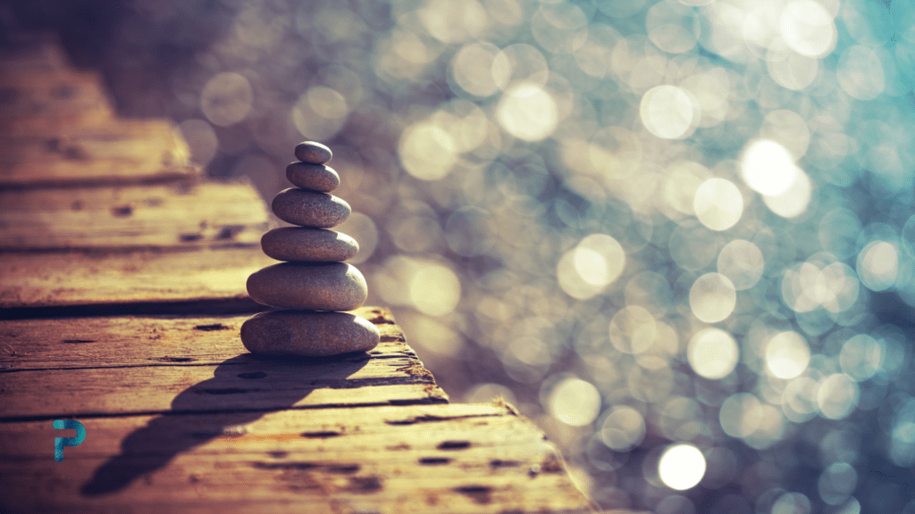 zen stone tower on boardwalk by ocean