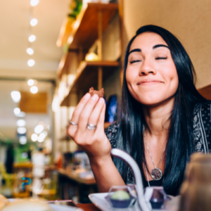 woman smiling while eating food