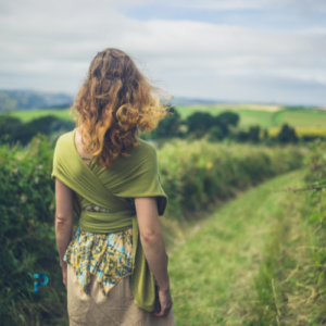 women walking in green field