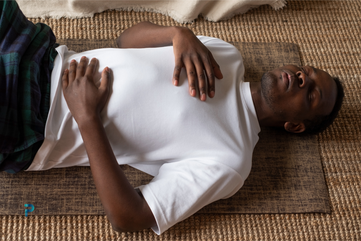 man performing coherent breathing while lying down