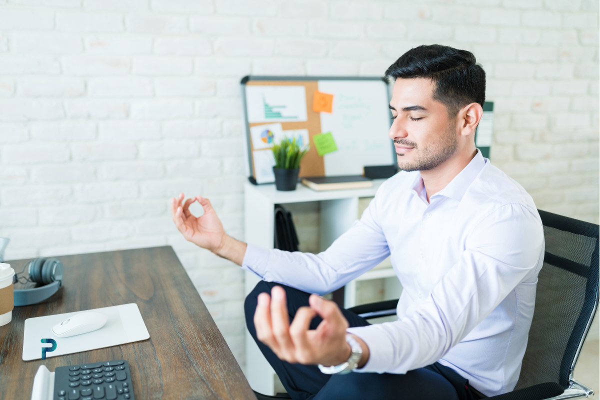 man sitting at office desk meditating