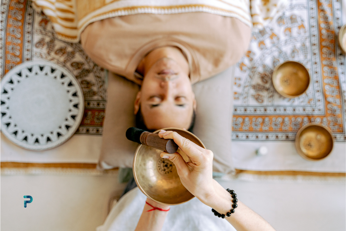 tibetan singing bowl over meditating man